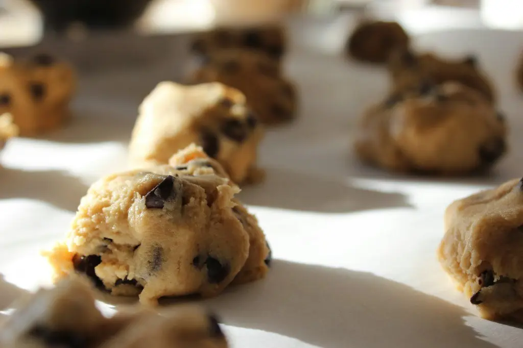 Chocolate chip cookie dough mounds on a baking tray