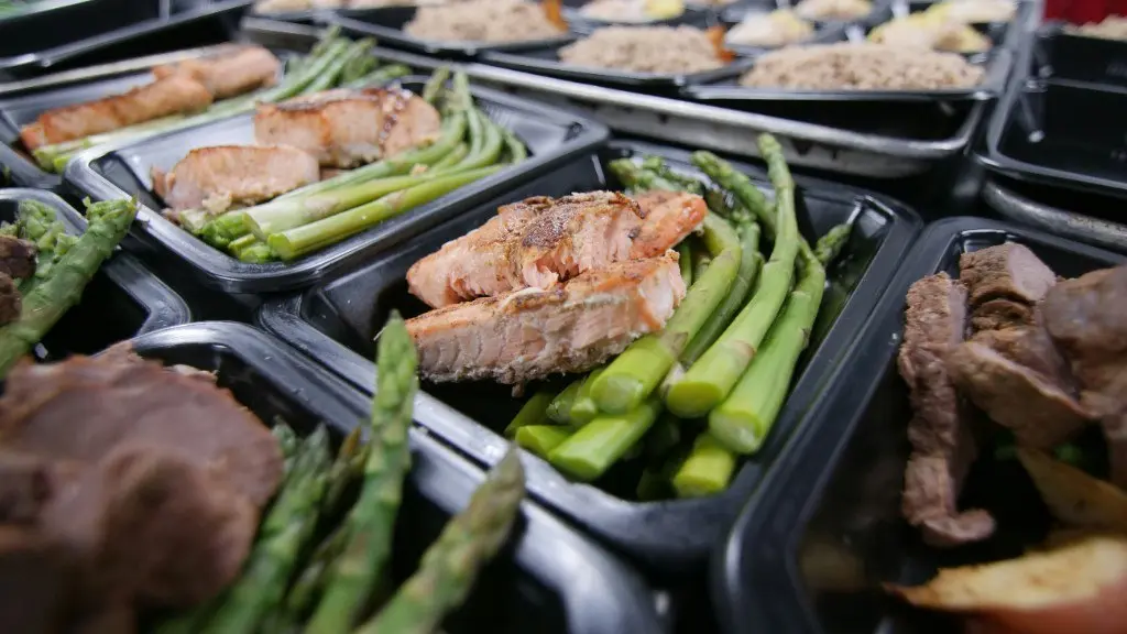 Prepared meal containers with salmon, asparagus, and steak